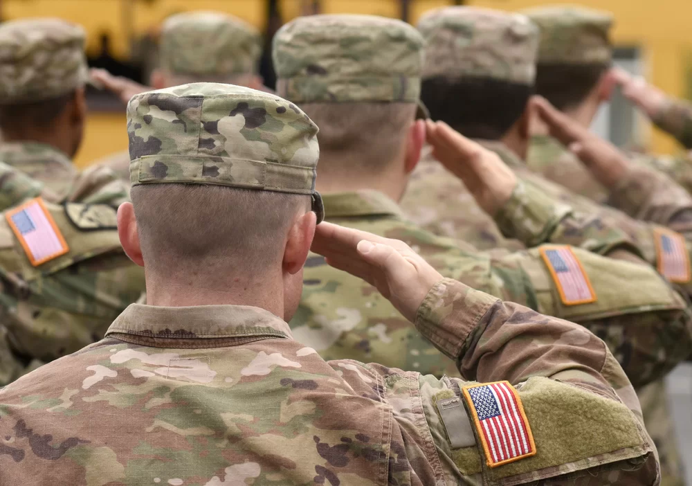 Military service members saluting in uniform