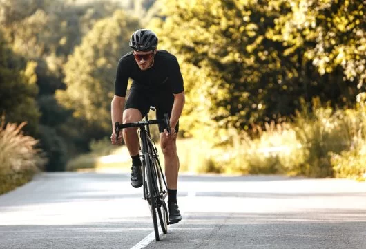 Man riding a bicycle on a wooded path