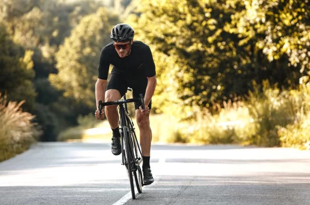 Man riding a bicycle on a wooded path