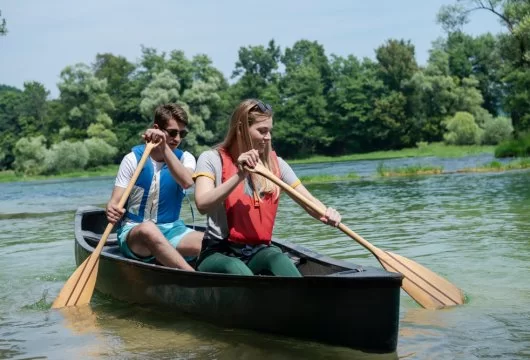 Man and woman paddling a canoe
