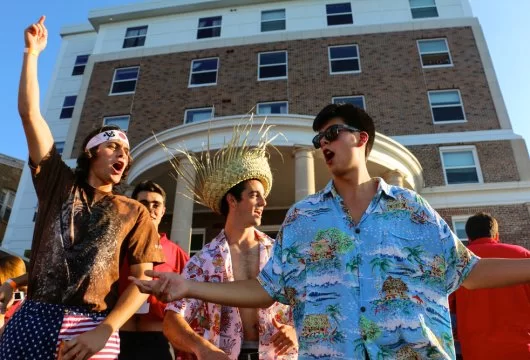 Fraternity members outside of their house during a party