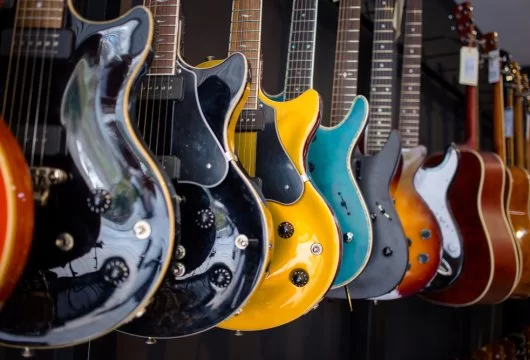 Guitars hanging on the wall of a music store