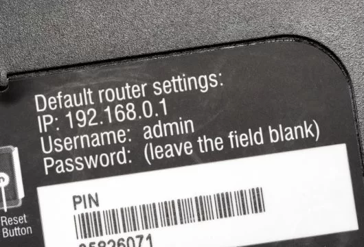 IP address, username, and password shown on a router sticker