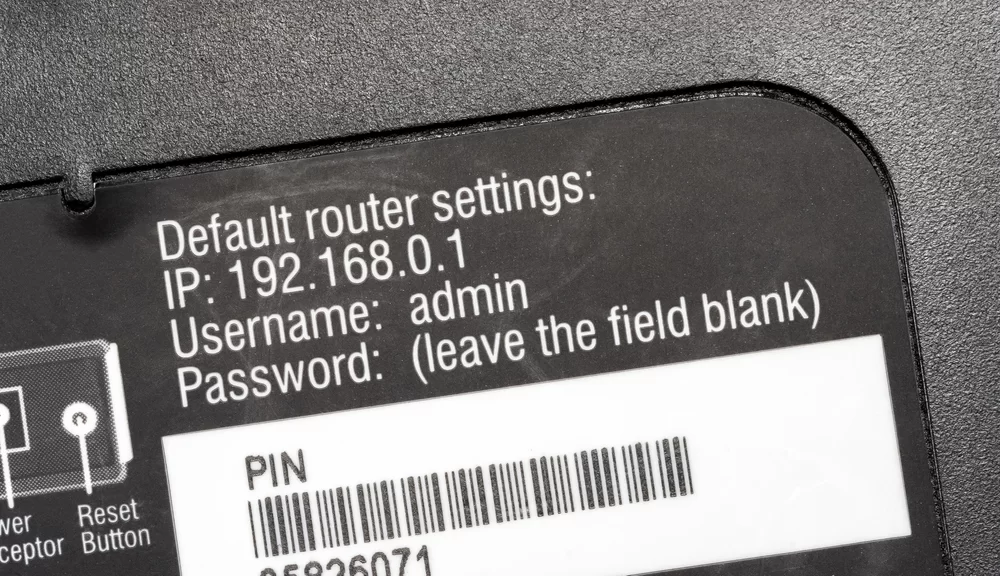 IP address, username, and password shown on a router sticker
