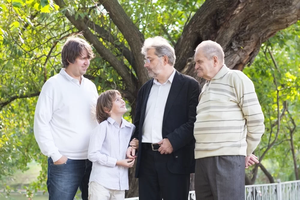 Four generations of family members standing together