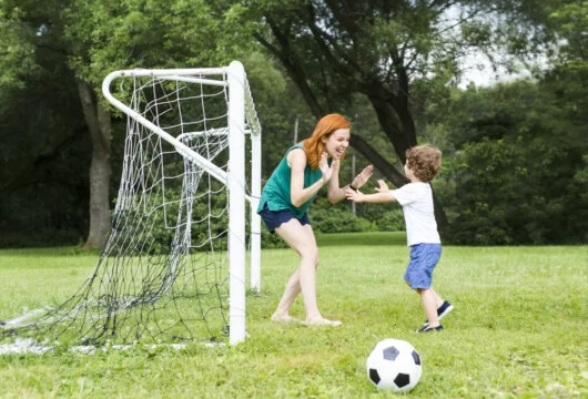 Soccer mom celebrating a good practice with her son