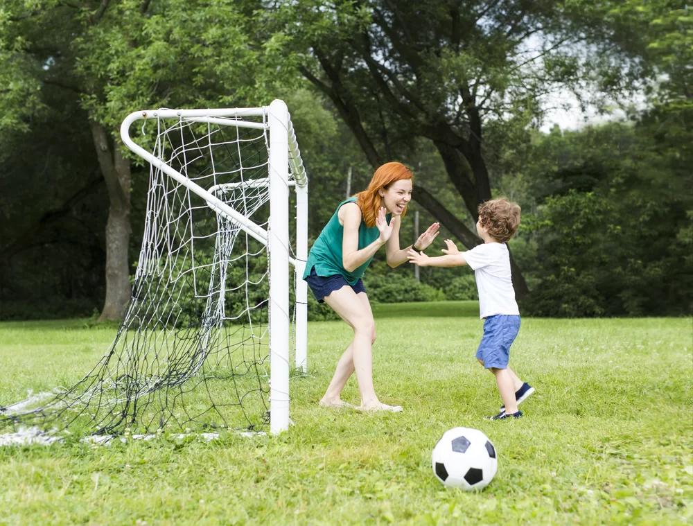 Soccer mom celebrating a good practice with her son