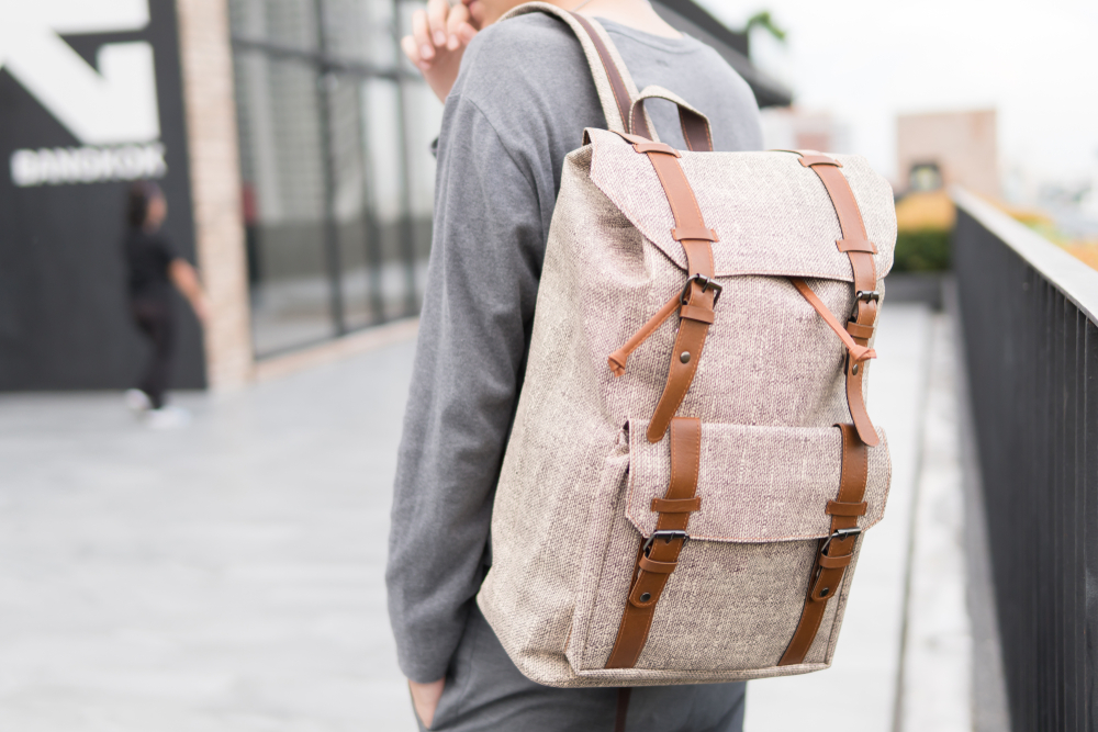 Man carrying a backpack, which starts with the letter b