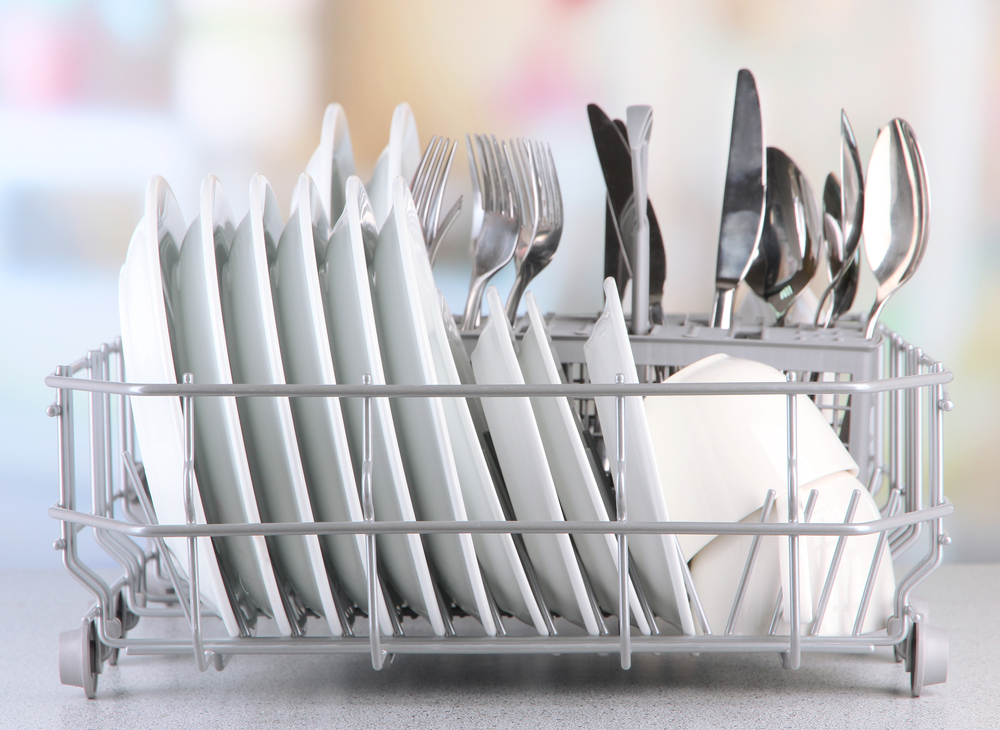 A dish drying rack full of white dishware