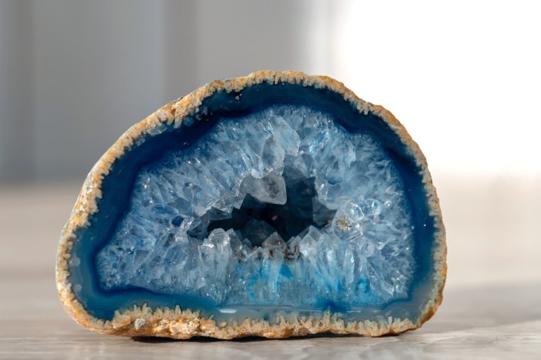 A geode, which starts with "g," used as decoration on a table
