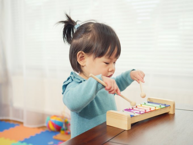 Young child playing with a xylophone