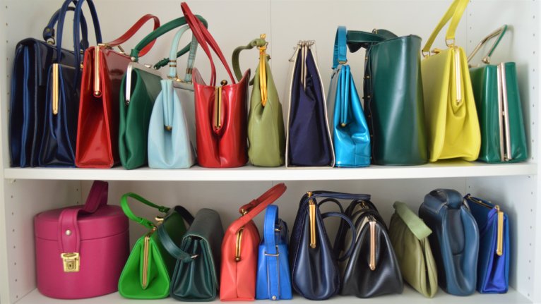 Colorful handbags on display in a closet