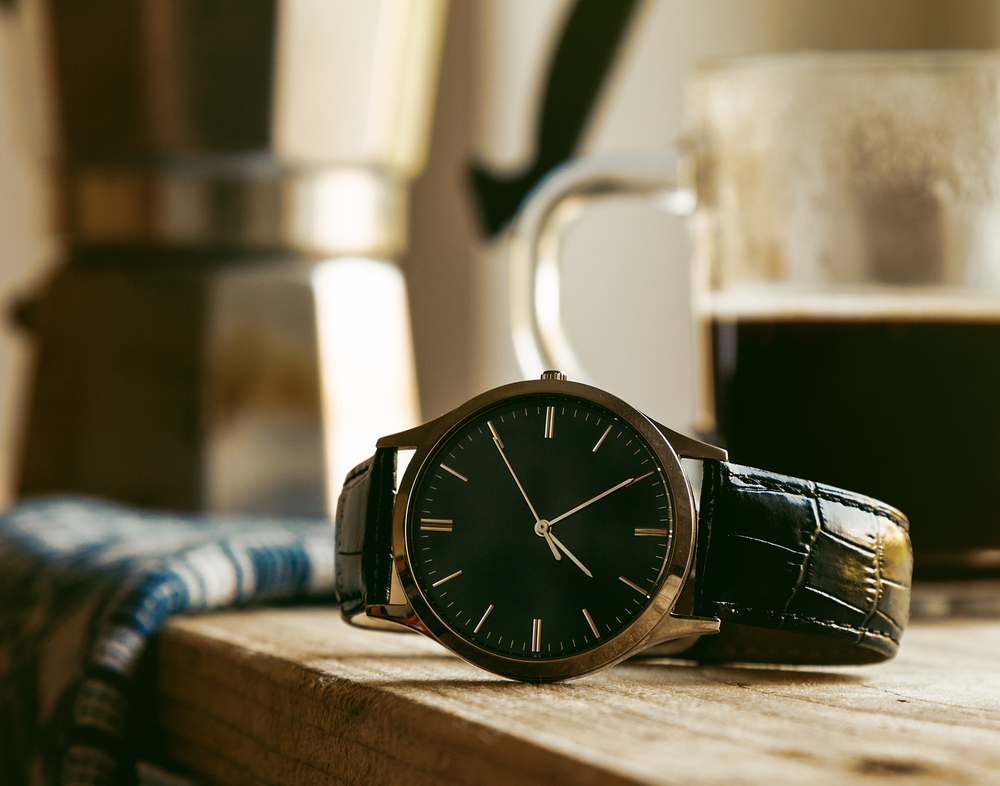 Wrist watch resting on a wooden countertop