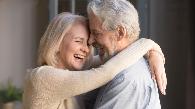Older couple hugging and smiling