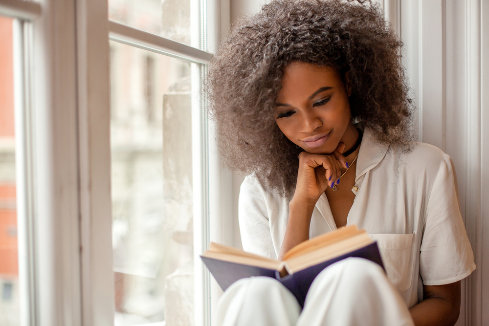 Woman reading by a window