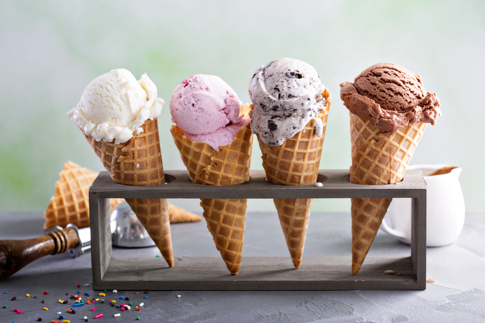 Four ice cream cones with a variety of ice cream flavors