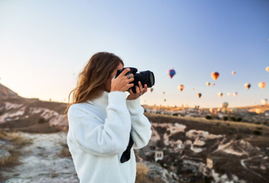 Photographer taking pictures of hot air balloons