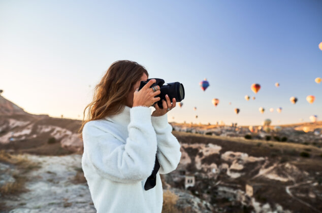Photographer taking pictures of hot air balloons