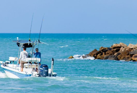 Small fishing boat heading out onto the water