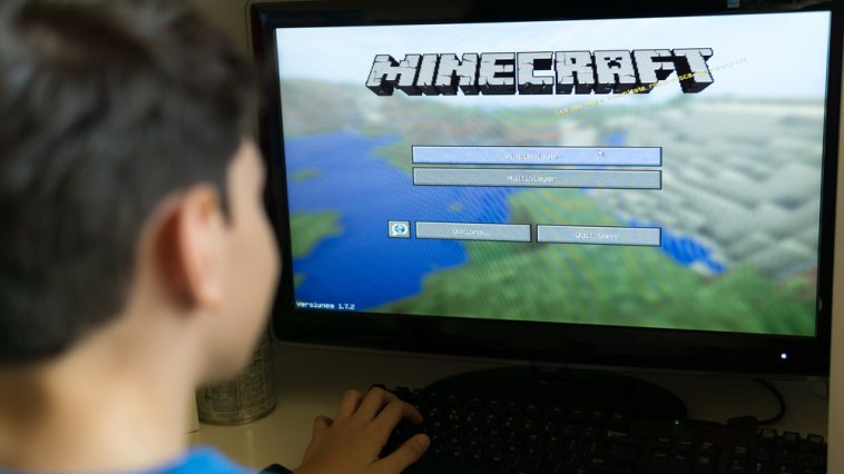 Young boy playing Minecraft on a PC