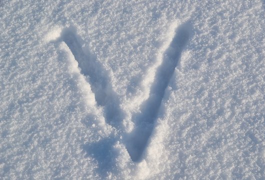 Letter "V" drawn in snow