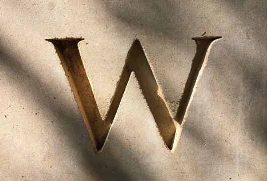 Letter "W" engraved in concrete