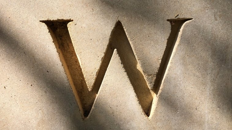 Letter "W" engraved in concrete