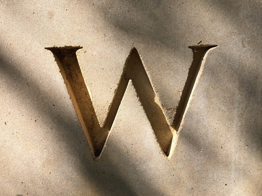 Letter "W" engraved in concrete