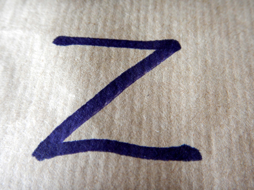 Letter "Z" written in blue marker on a white sheet of paper