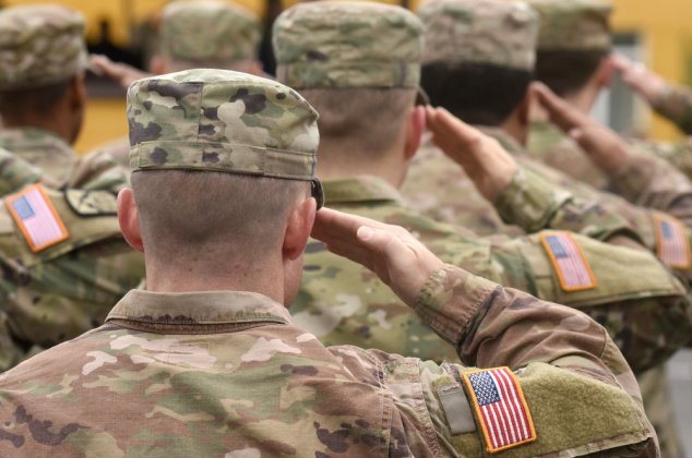 Military service members saluting in uniform