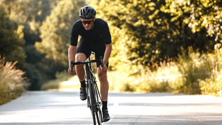 Man riding a bicycle on a wooded path