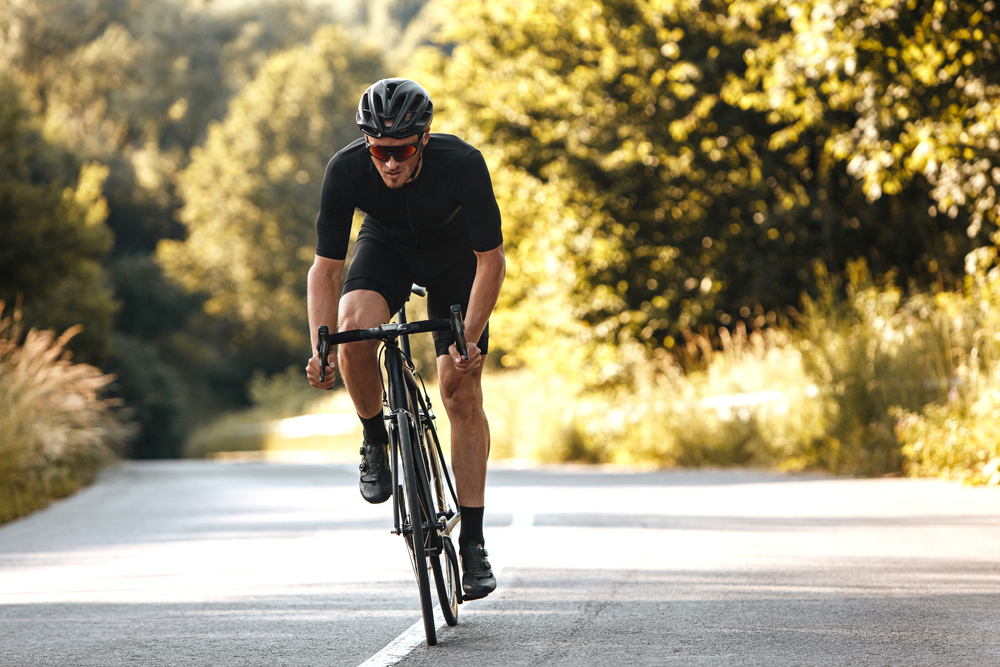 Man riding a bicycle on a wooded path