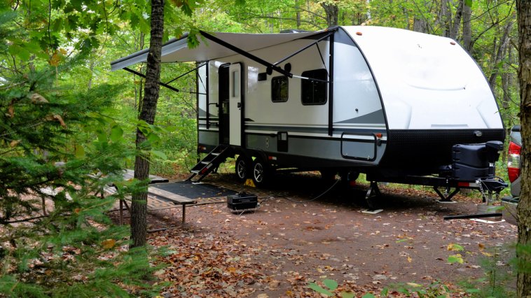 Camper parked in a wooded campsite