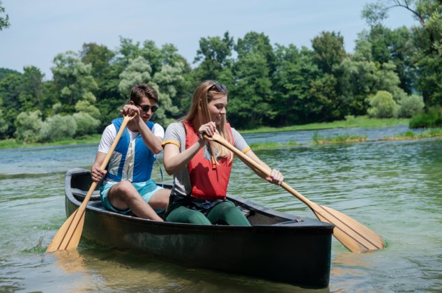 Man and woman paddling a canoe