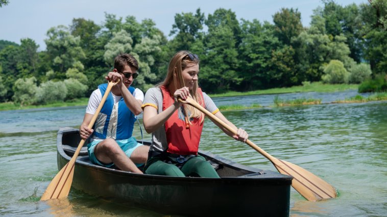 Man and woman paddling a canoe