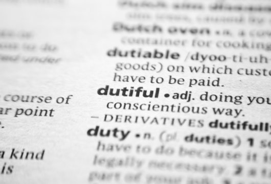 The character trait "dutiful" shown on a dictionary page
