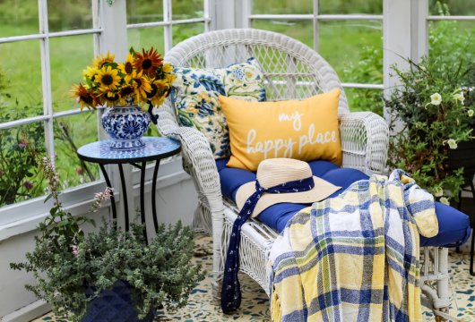 Wicker chair and flowers in a she shed