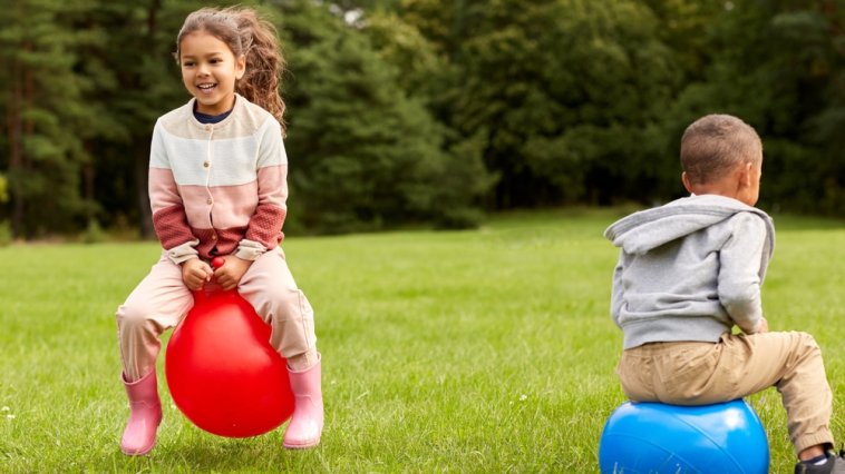 Children bouncing on inflatable hoppers