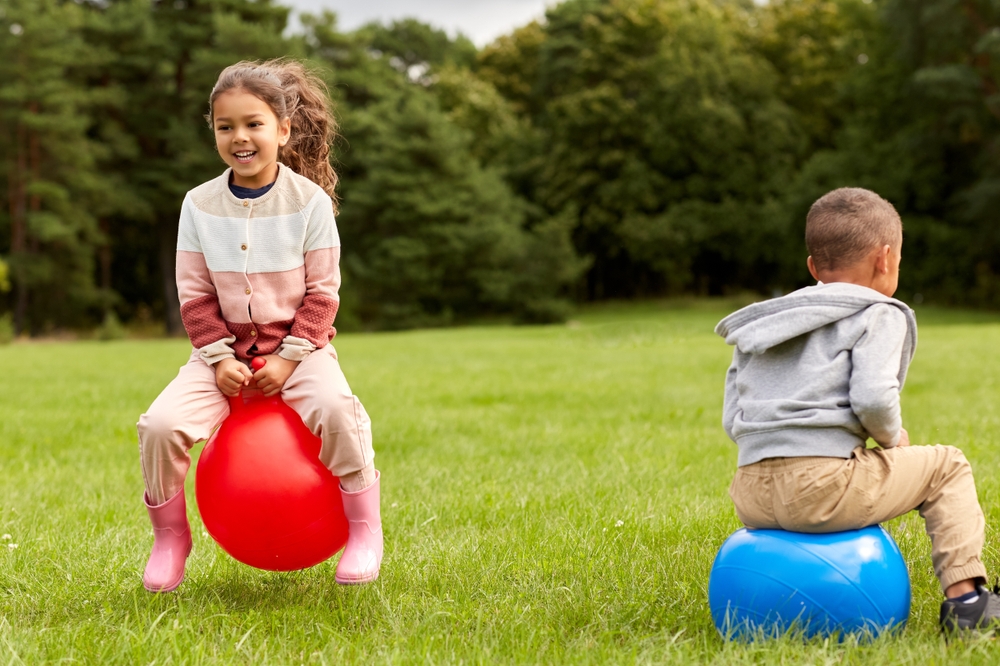 Children bouncing on inflatable hoppers