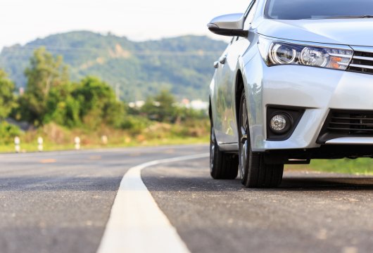 Car parked on the shoulder of a highway