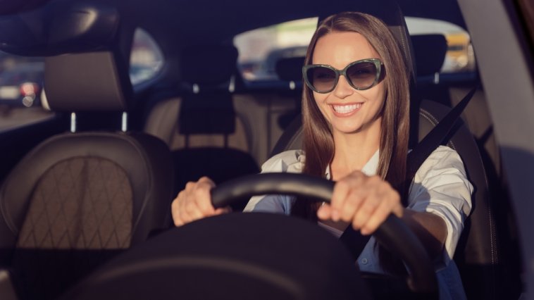 Smiling girl driving a car