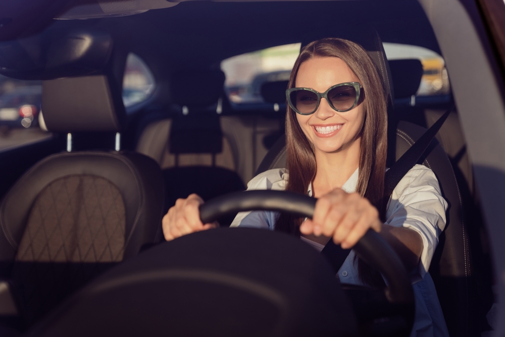 Smiling girl driving a car