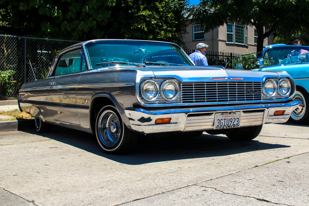 Classic lowrider car parked in front of a house