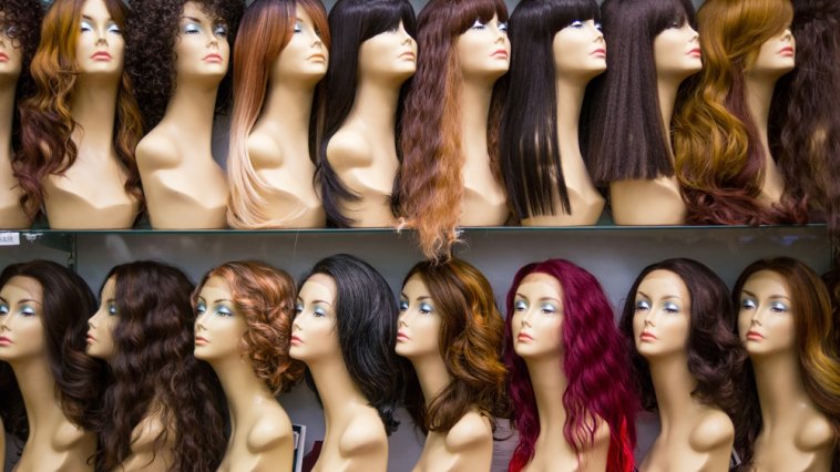 Mannequins wearing wigs in various colors and styles