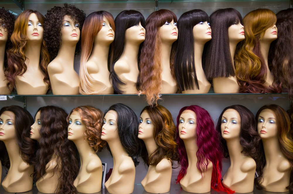 Mannequins wearing wigs in various colors and styles
