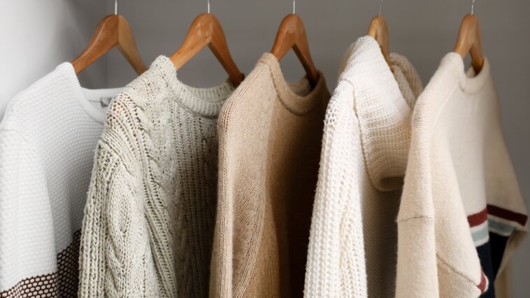 Knitwear hanging in a closet