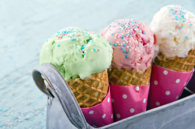 Three ice cream cones with sprinkles in a carrier