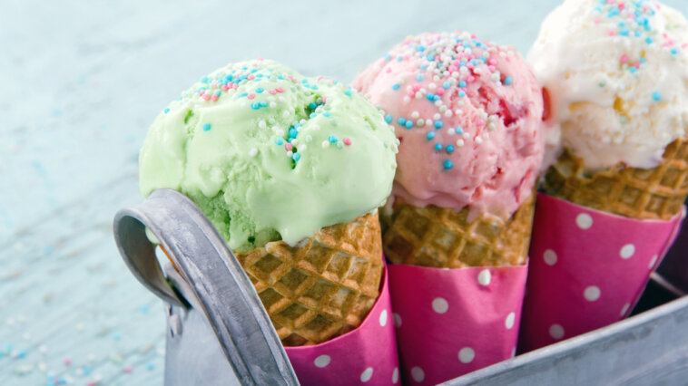 Three ice cream cones with sprinkles in a carrier